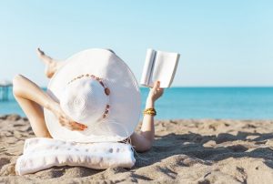 Summer Reading woman reading on beach