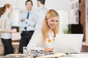 Business woman using laptop uncovering your authentic self