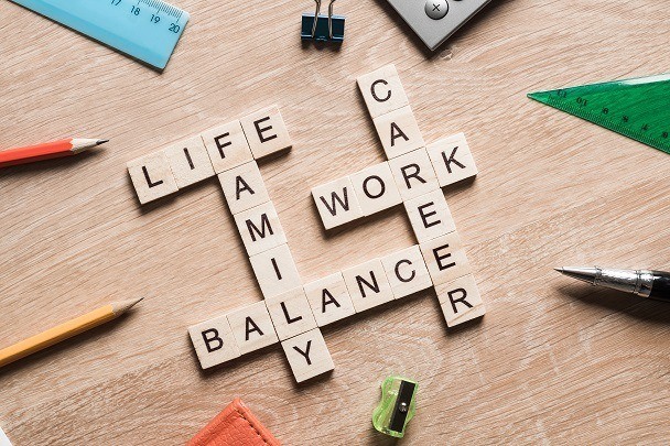Scrabble blocks with words work life family career intersecting to represent employee morale and retention strategies